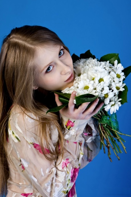 Young beauty Daisy Gold holds a bouquet of flowers before getting bare naked 58610397