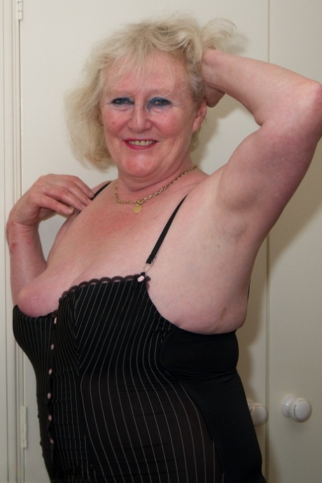 Blonde granny Claire Knight finger fucks her bald pussy in stockings on a bed 97793643