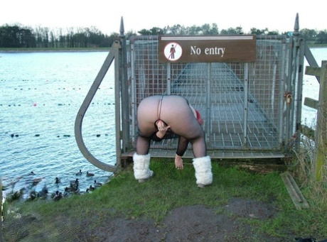 Redhead Valgasmic Exposed plays with a toy in a park in a crotchless stocking 19973389