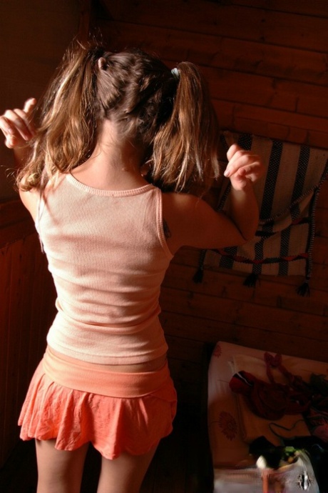 Young looking girl goes topless with her hair set in pigtails 55026271