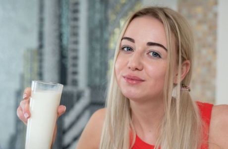 Busty blonde teen Iva gets bare naked over a big glass of milk 27314423