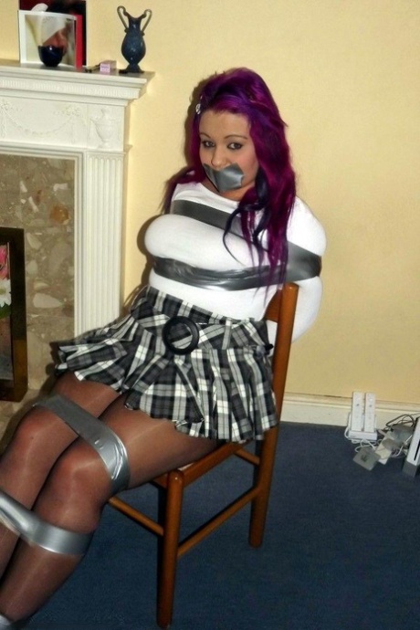 Busty girl with pink hair finds herself gagged and restrained to a chair 35299506
