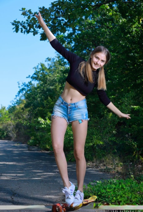 Teen solo girl Dakota Pink bares her heavenly body on a paved road 81744424