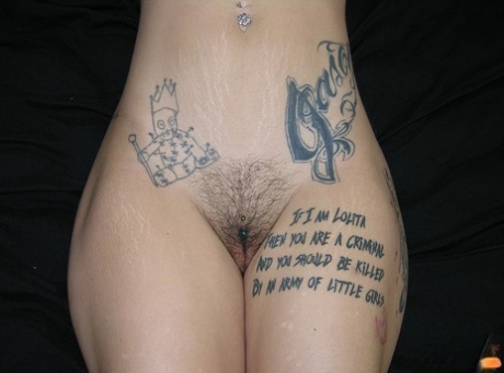 Tattooed redhead Jae Model displays her pierced bush after going nude 41264423
