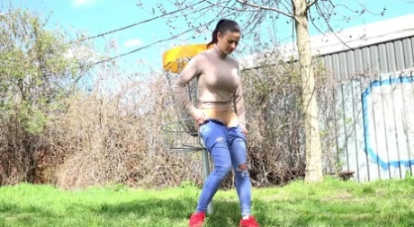 Pretty brunette Billie Star gets caught taking a pee upon the green grass 11051381