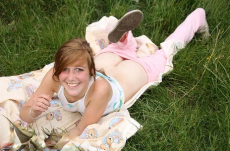 Teen amateur disrobes before fingering her pussy on a blanket out in the yard 77455945