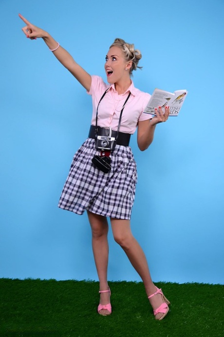 Blonde pinup model lets her hair down while going topless in a casual manner 24304997