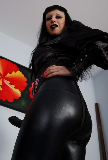 Seductive mature fetish babe posing with strapon over her latex leggings 42500739